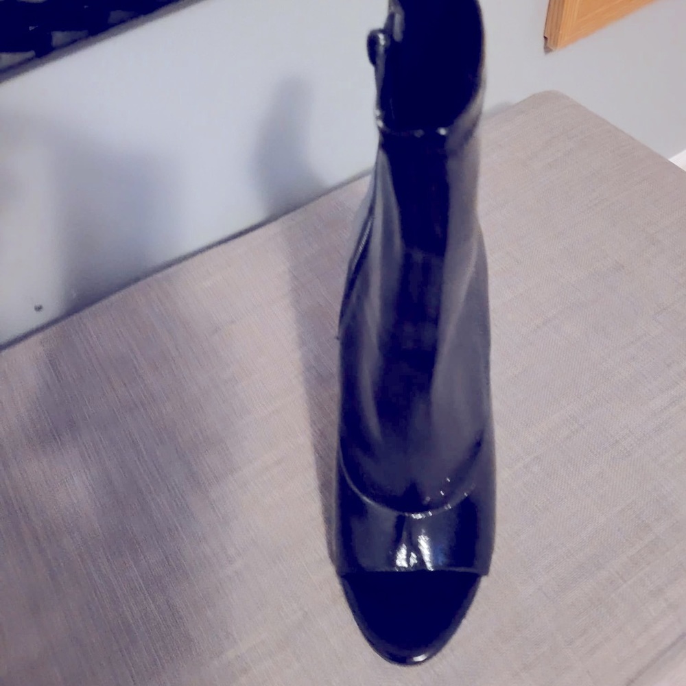 Open towed patent leather high heel boots.